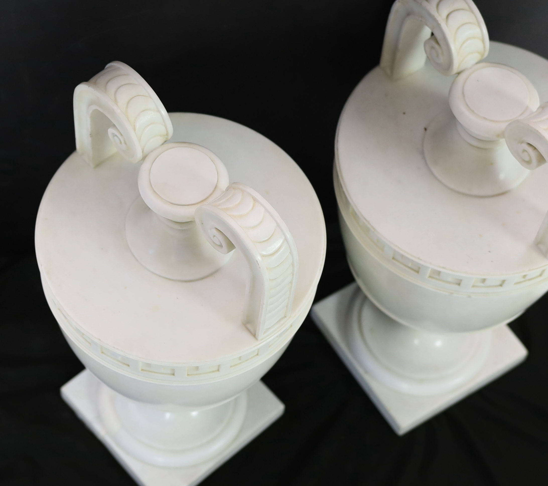 A pair of Italian neo-classical Carrara marble vases, 24cm diameter, 50cm high, Please note this lot attracts an additional import tax of 5% on the hammer price